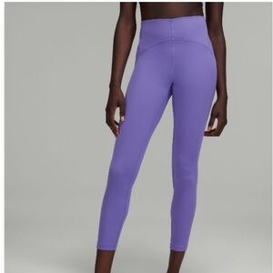 In still high rise tight “25 in. Size 8. Never worn. No tags.